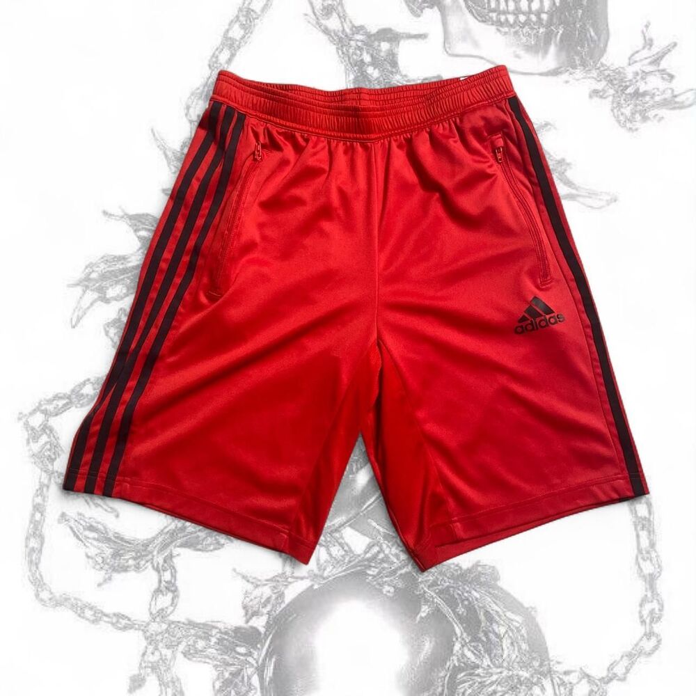 Red Adidas shorts with black stripes
